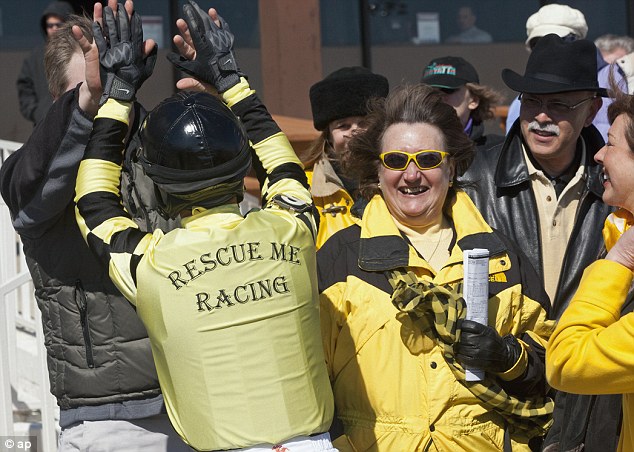 Rescue: Gail Vacca, center, the founder and president of the Illinois Equine Rescue Center, purchased the horse's mother at a slaughter auction and later found out the horse was pregnant with Magna Fortuna