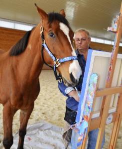 Metro wields a paintbrush as owner Ron Krajewski looks on at Motters Station Stables in Rocky Ridge, Md. ~ Jeffrey B. Roth/Reuters/Landov