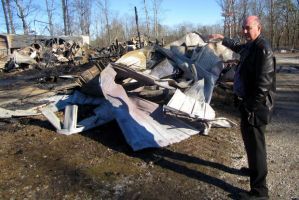 Carroll Williams points to where he and his wife, Atha, kept 12 quarter horses killed in a fire early Saturday. A lightening strike caused a fire that burned up a barn with the horses as well as 13 cats, a dog, six vehicles and antiques. The two-story barn was made of oak and occupied 13,000 square feet. (Paul Huggins/phuggins@al.com)