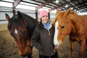 Horsewoman Valerie Buck with Whiskey, left, and Budder on Wednesday, Jan. 7, 2015, at Long Shadows Farm in Cambridge, N.Y. Buck, formerly with Saratoga War Horse, has started a new equine therapy program for women who have experienced trauma called ACTT Naturally. (Cindy Schultz / Times Union)